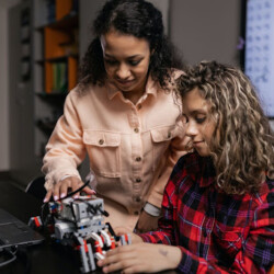 Parent and child playing with a robot