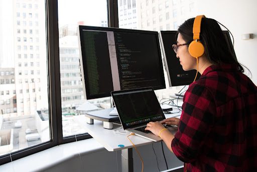 girl coding on a desktop 