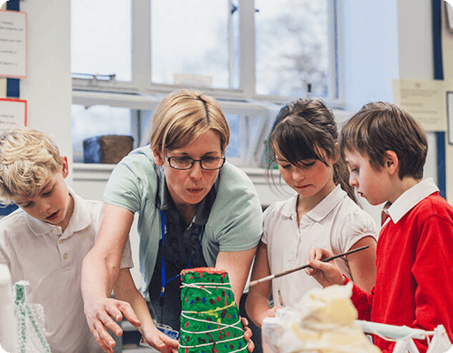 Students and a teacher creating a volcano 