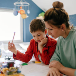 A picture of a mom helping son with school work.