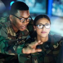 A picture showing two military officers where male officer explaining female officers something.